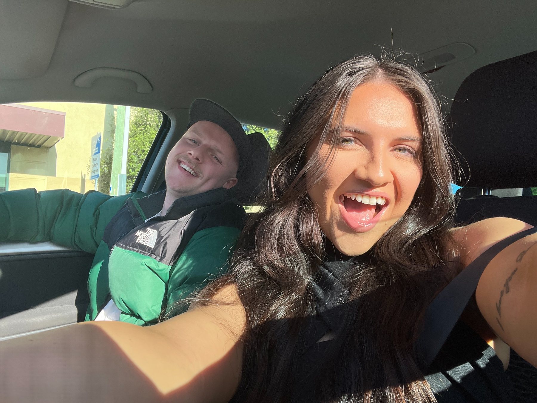 Bianca and Tom smiling in the car