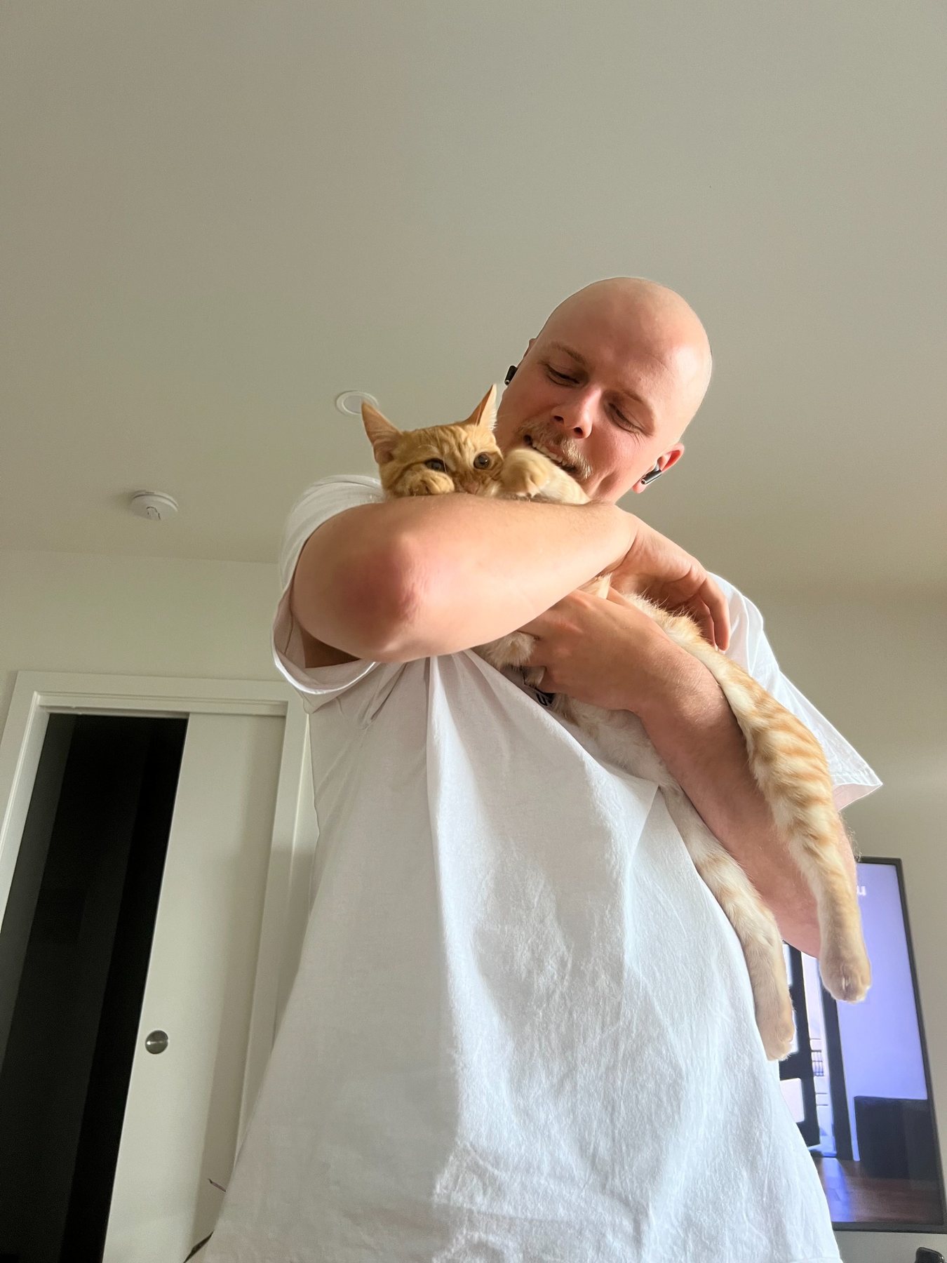 Tom cuddling Elfie the cat
