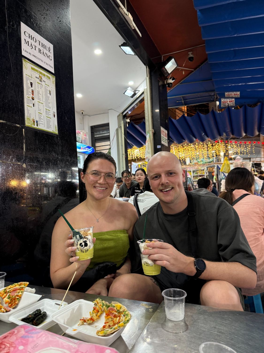 Bianca and Thomas enjoying drinks at a night market