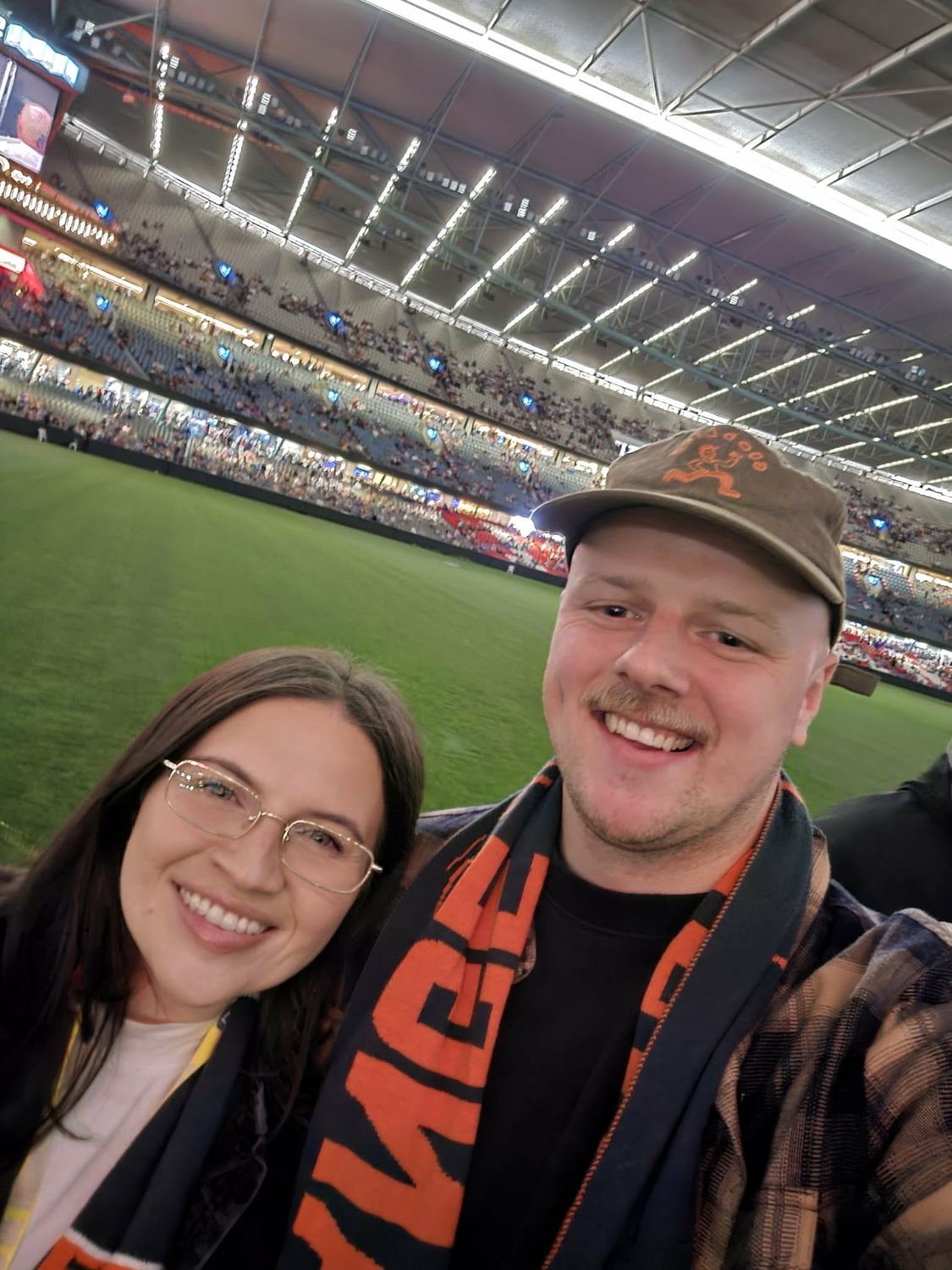 Bianca and Thomas smiling at the stadium