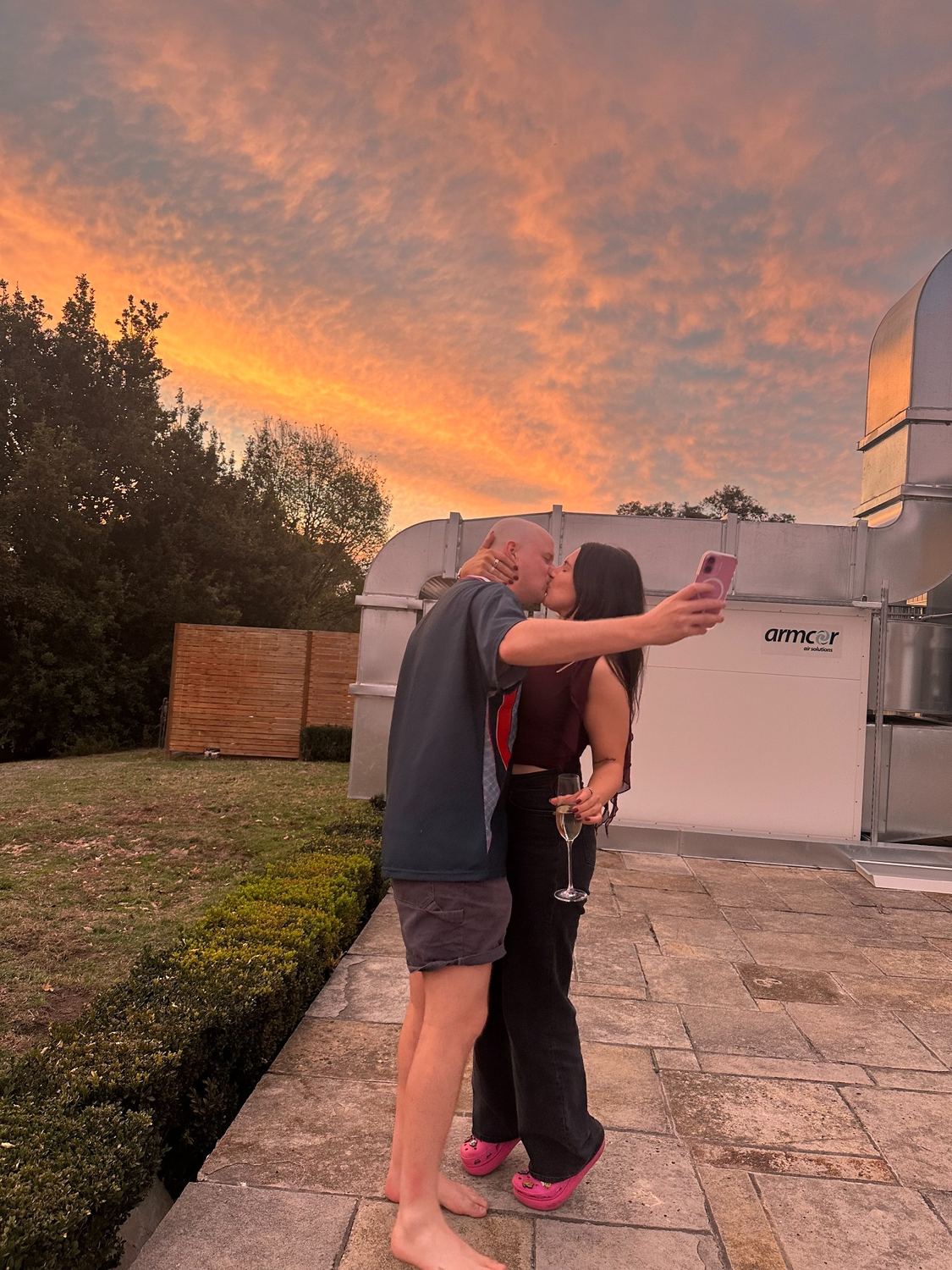 Bianca and Thomas kissing under a sunset